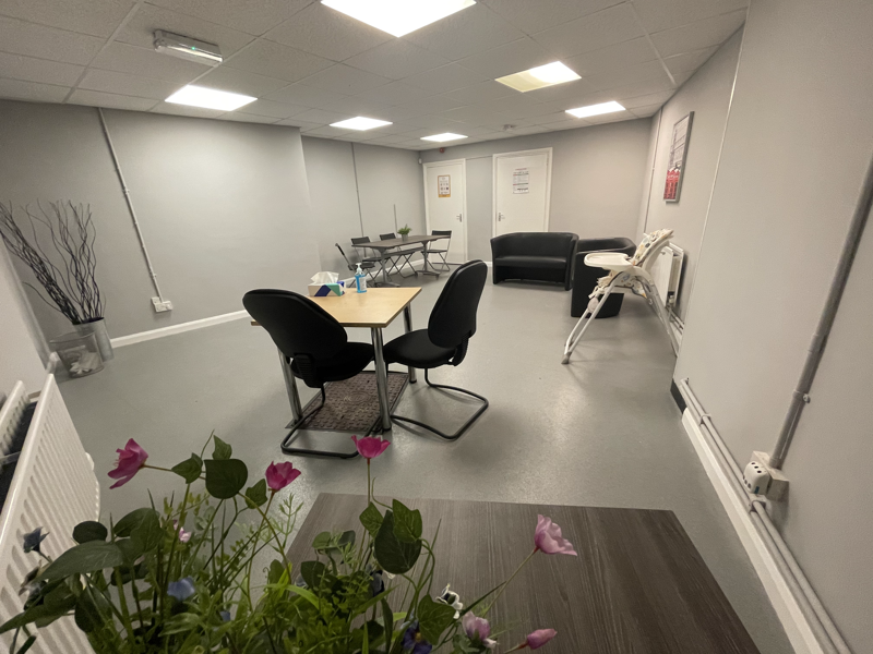 room with sofas, table and chairs 