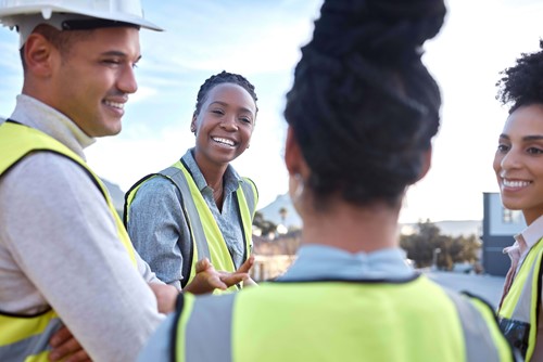 employees in hi-vis jackets talking 