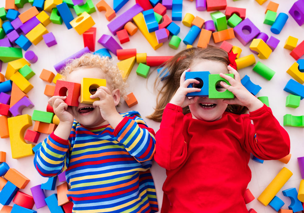 two children playing with toys in a daycare setting 