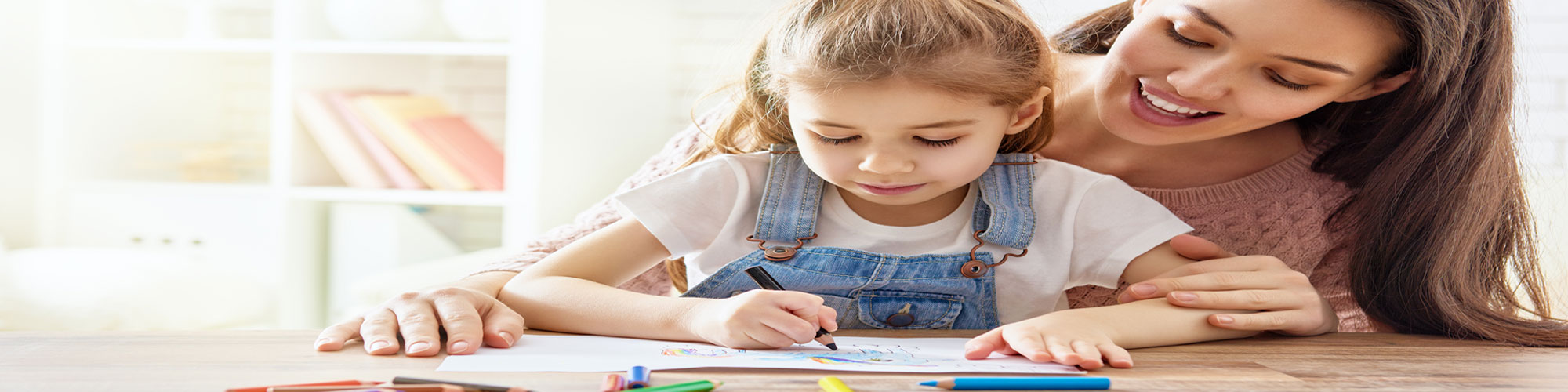 child being helped by adult with school work 