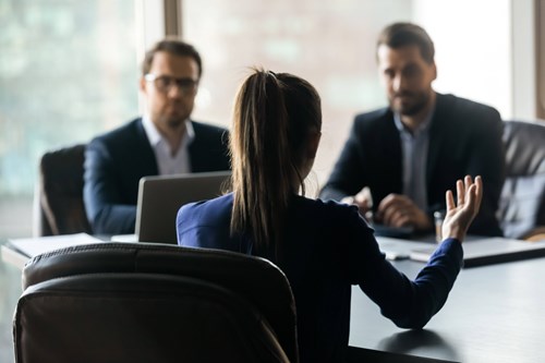 Colleagues talking in a conference room/ meeting setting