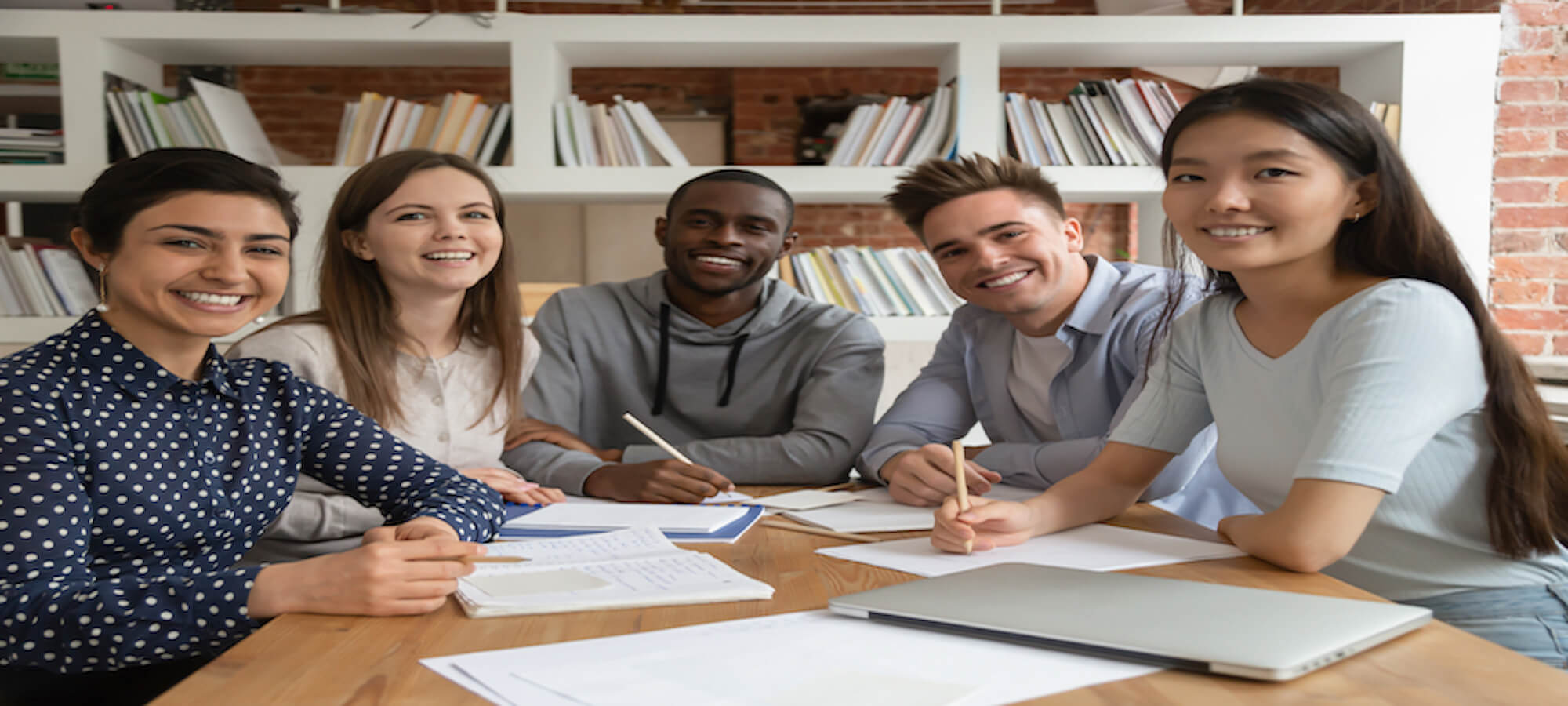 student smiling whilst studying 